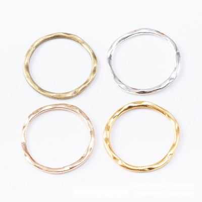 Hammered Round Open Rings in Four Metallic Finishes in multiple metallic finishes displayed together on a white backgrou