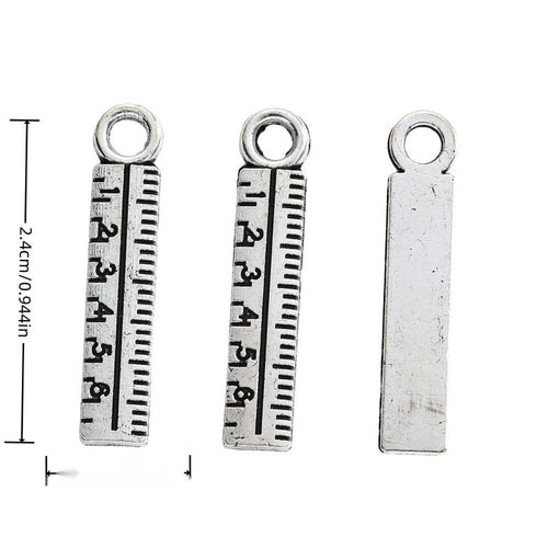 Front-facing arrangement of ruler charms on a white background