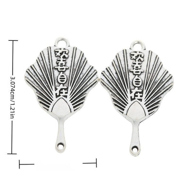 Folding fan charm with radiating ribs, raised characters, and two loops shown in arranged finish comparison