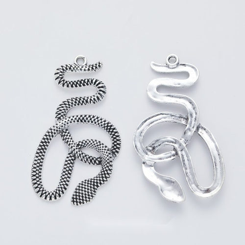 Front-facing arrangement of coiled snake charms on a white background