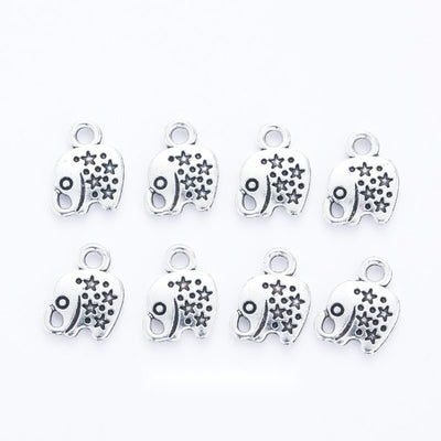 Small antique silver-tone elephant charm with floral and dot patterns