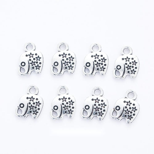 Small antique silver-tone elephant charm with floral and dot patterns
