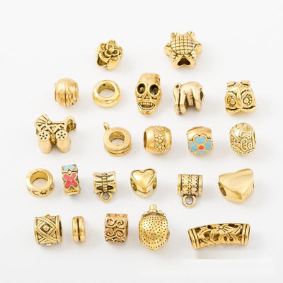 Assorted Gold Tone Large Hole Beads showing assortment on a white background