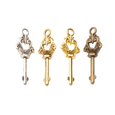 Grouped front view of crown key charm showing an ornate crown bow and slender shaft