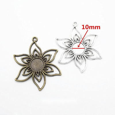 Floral Cabochon Pendant Settings in Two Finishes in multiple metallic finishes displayed together on a white background.