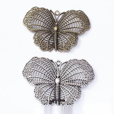 Antique Bronze, Antique Silver textured butterfly charm shown in an overview