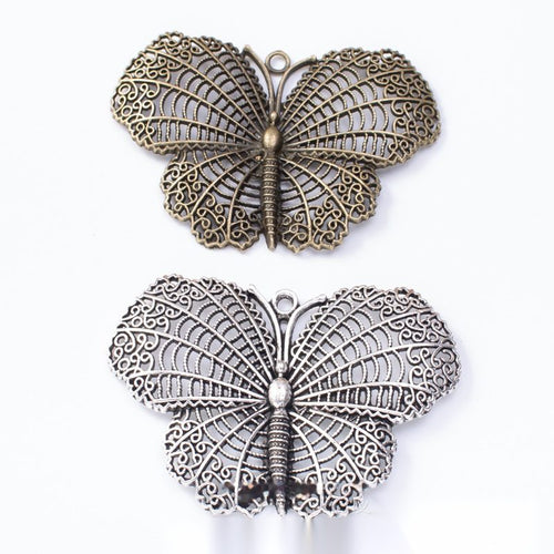 Antique Bronze, Antique Silver textured butterfly charm shown in an overview