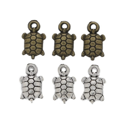 Tiny Textured Turtle Charm shown in all pictured finishes on a white background