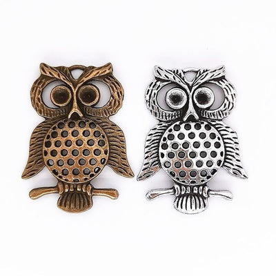 Openwork owl metal component, grouped front view on white