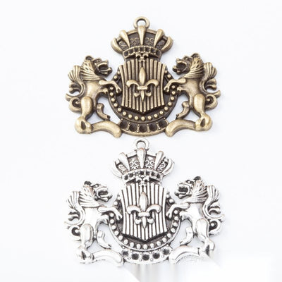 Group view of crowned lion crest charm on a white background
