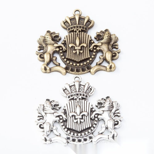 Group view of crowned lion crest charm on a white background