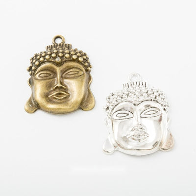 Finish comparison of 佛首 charm on a white background