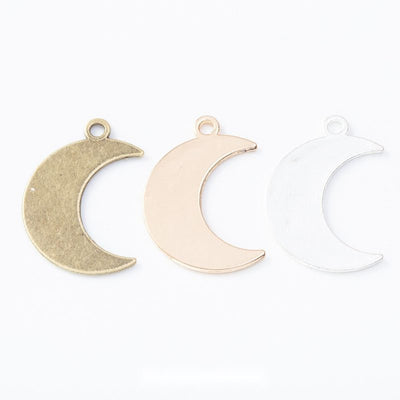 Group view of the crescent moon charm showing the available finishes and front details