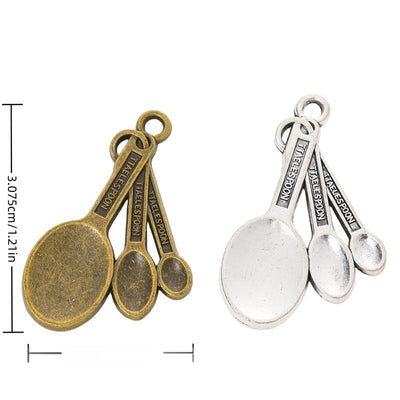 Measuring Spoon Cluster Charm finish comparison on a white background