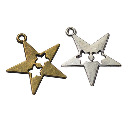 Assorted antique bronze and antique silver double star cutout charm pieces on white