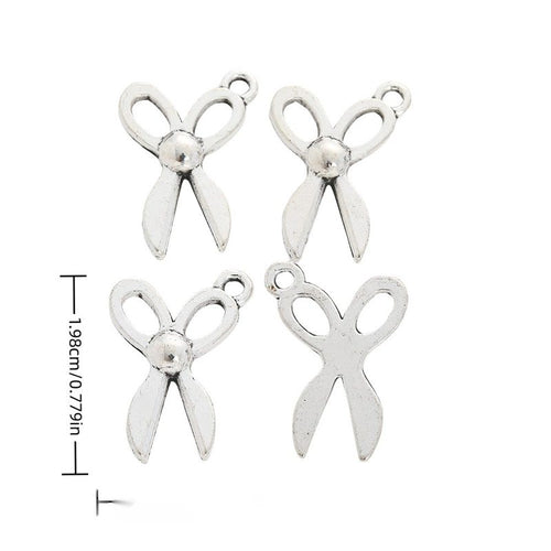 Front and reverse views of small scissors charms with measurement and weight guides