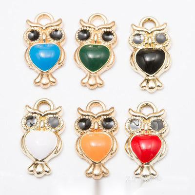 Owl with a colored enamel belly shown across the available colors