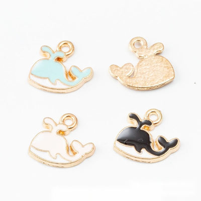 Rounded whale with a curled tail and gold-tone outline shown in the available finishes
