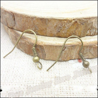 Assorted fishhook earring wires arranged together on a white background