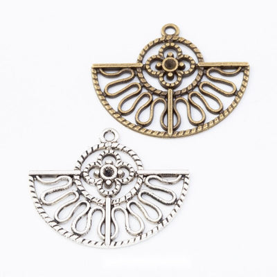 Group view of the openwork fan charm showing the available finishes and front details