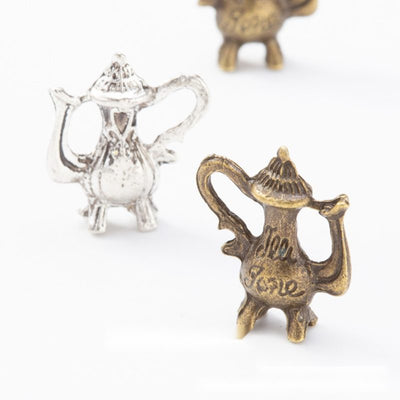 Front and finish comparison of coffee pot charm