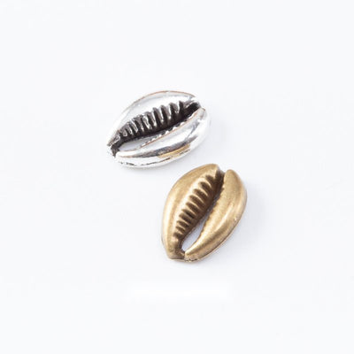 Cowrie Shell Metal Charm Pendant shown in the available visible finishes