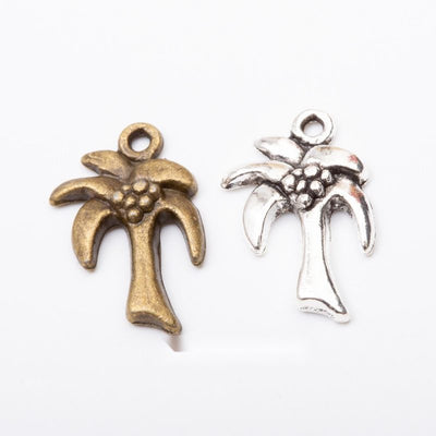 Grouped front views of the palm tree pendant charm in two antique metal finishes