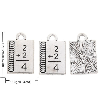 Math Formula Book metal piece shown in Antique Silver beside printed specifications