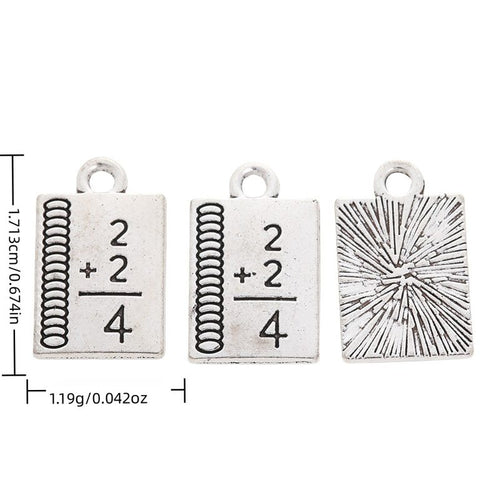 Math Formula Book metal piece shown in Antique Silver beside printed specifications
