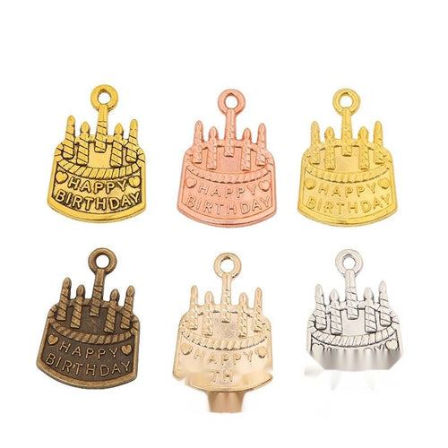 Overview of birthday cake charm pieces on a white background