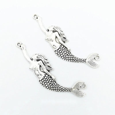 Group view of mermaid charm showing all 1 pictured finish variants