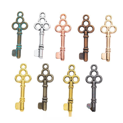 Ornate Key Charm grouped finish options on a white background