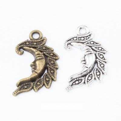Front view of filigree crescent moon charm showing finish variation 1