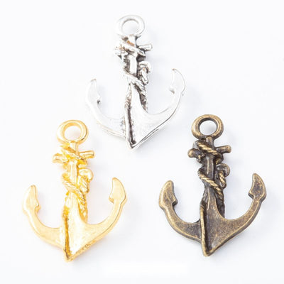 Assorted anchor charms arranged together on a white background