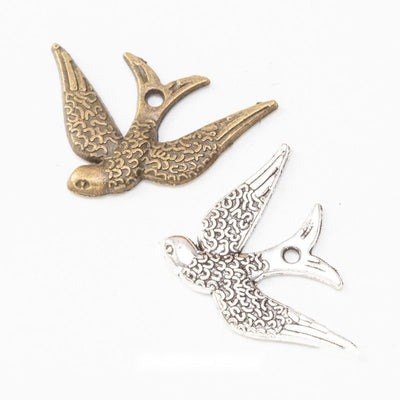 Grouped front views of swallow charms