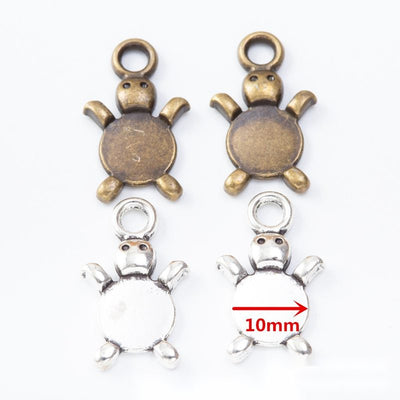 Small turtle charms with smooth round recessed belly panels arranged together on a white background.