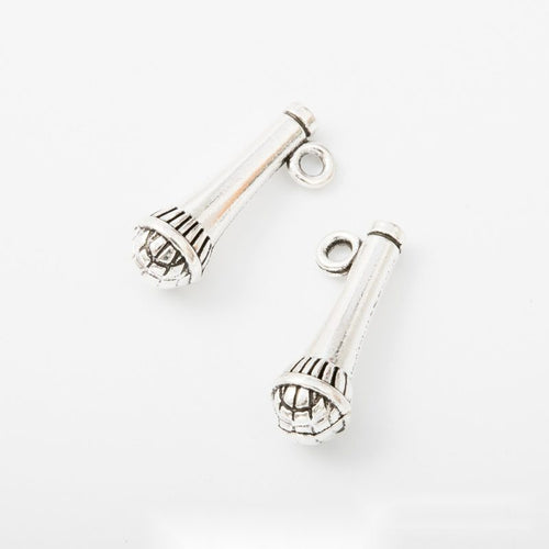 Group view of handheld microphone charm on a white background