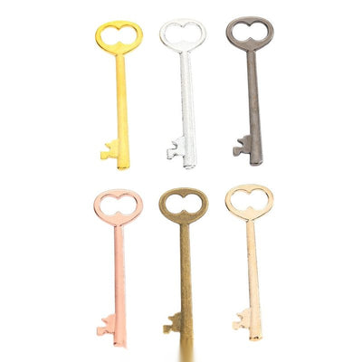 Heart Bow Key Charm Pendant finish comparison showing a heart-shaped bow and a classic long key shaft