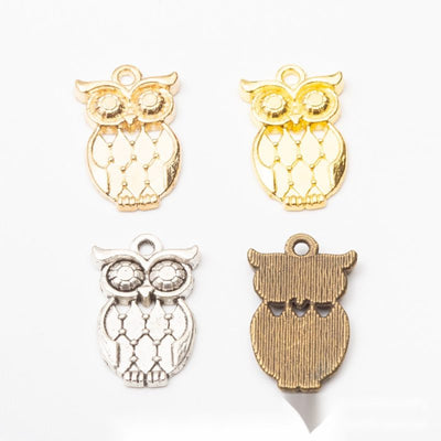 Grouped front views of openwork owl charms