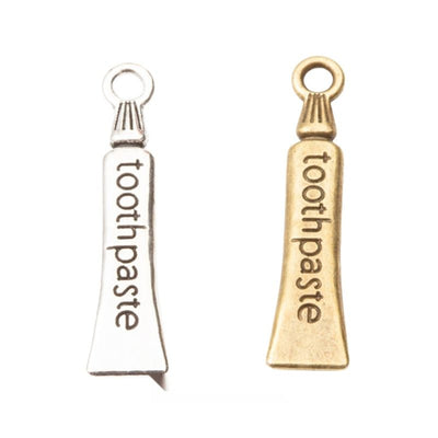 Toothpaste Tube Charm grouped finish options on a white background