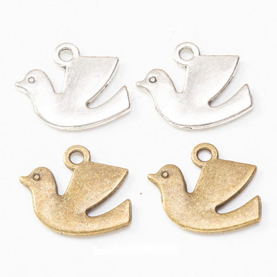 Grouped front views of the flying dove silhouette charm in two antique finishes