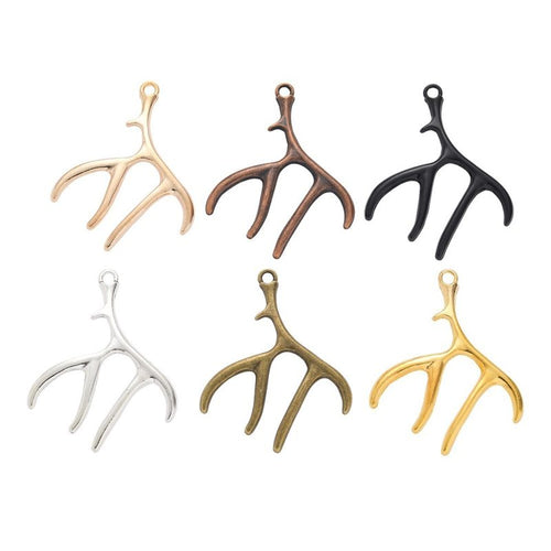 Overview of branching antler charm pieces on a white background