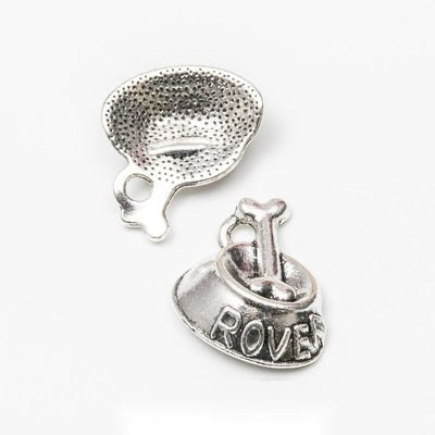 Product view of dog bowl charm showing a textured dog bowl filled with bones and embossed with the word ROVER