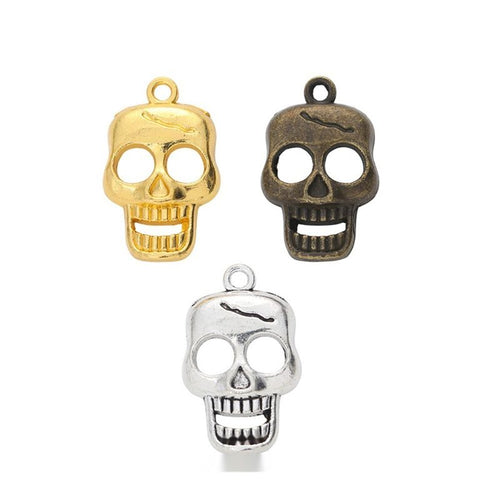 smiling skull metal charm shown from the front in the available metallic finishes