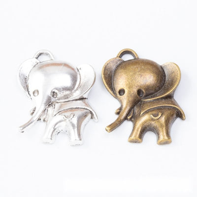 Assorted walking elephant charms arranged together on a white background
