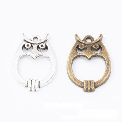 Grouped front views of the owl shaped open center connector in two antique finishes