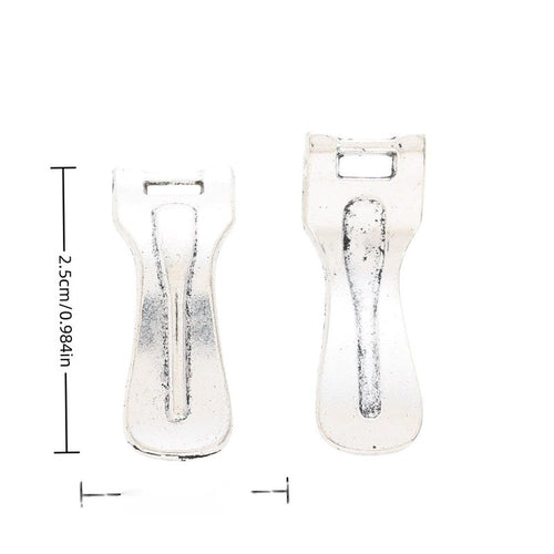 Front and reverse views of vegetable peeler charms with measurement and weight guides