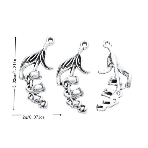 Metal trumpet flower charm, front and reverse views shown in the product image