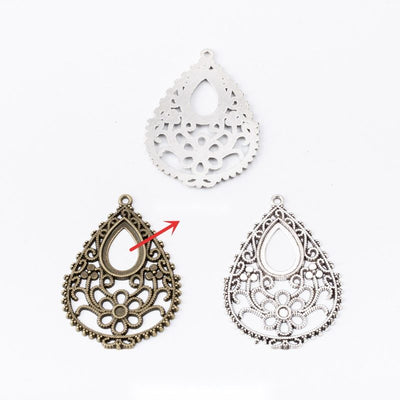 Grouped front view of filigree teardrop cabochon settings in the available finishes