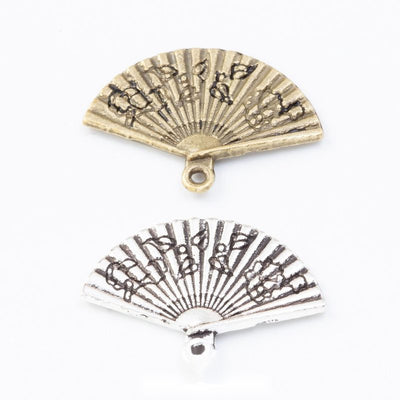 Group view of the folding fan charm showing the available finishes and front details
